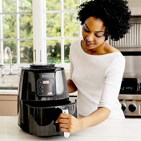 Ninja Power Air Fryer Oven - woman opening the basket section